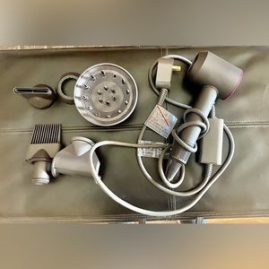 Used Dyson Supersonic™ hair dryer Fuchsia with 5 attachments.